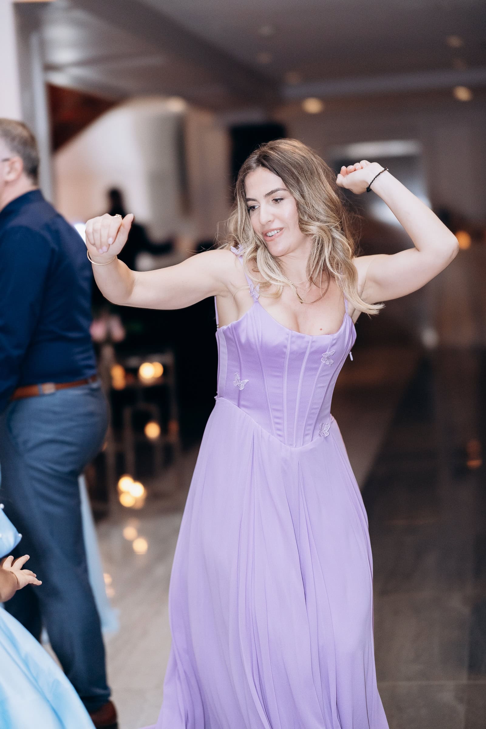 Woman dancing in a lavender corset dress with butterfly details at an indoor event at Hudson House, Jersey City, NJ.