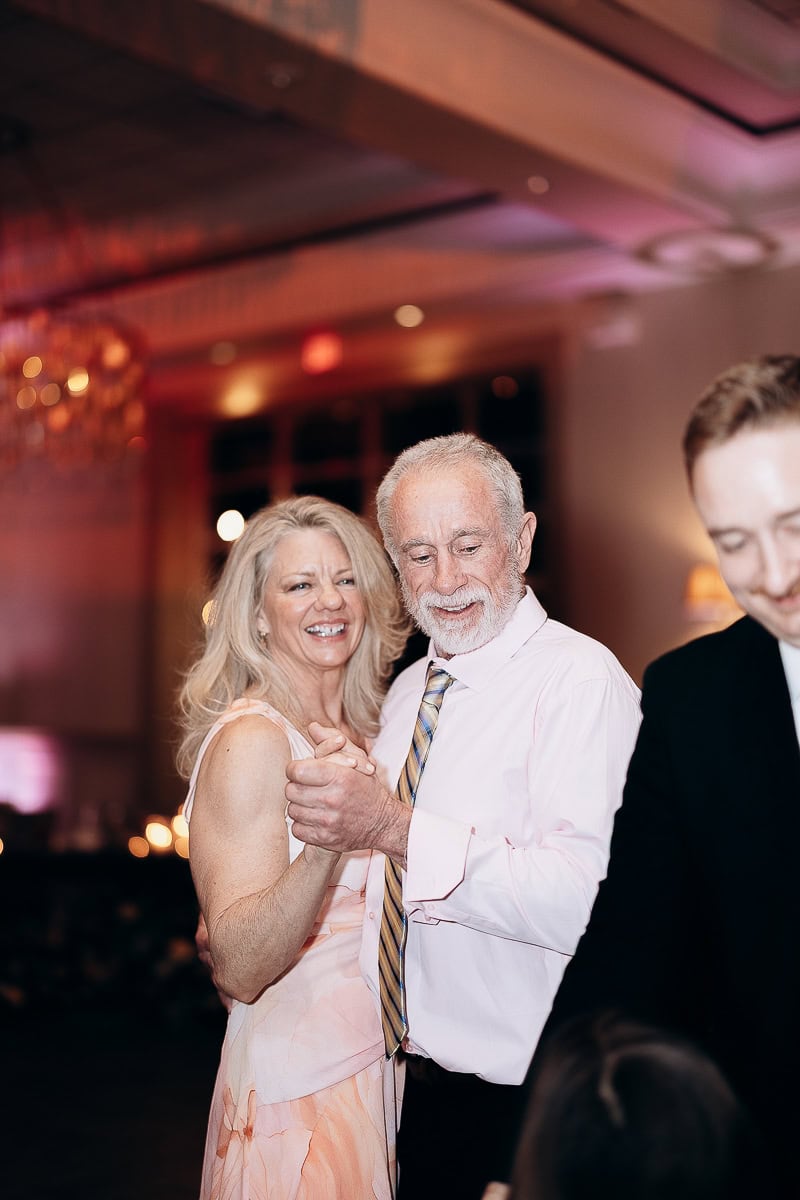 Mature couple dancing closely in soft evening light at a wedding reception, The Stone House, Warren, NJ.
