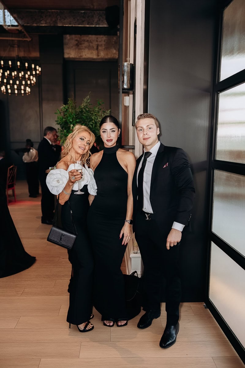 Three guests in black attire pose during cocktail hour at The Switch House by Cescaphe, Philadelphia.