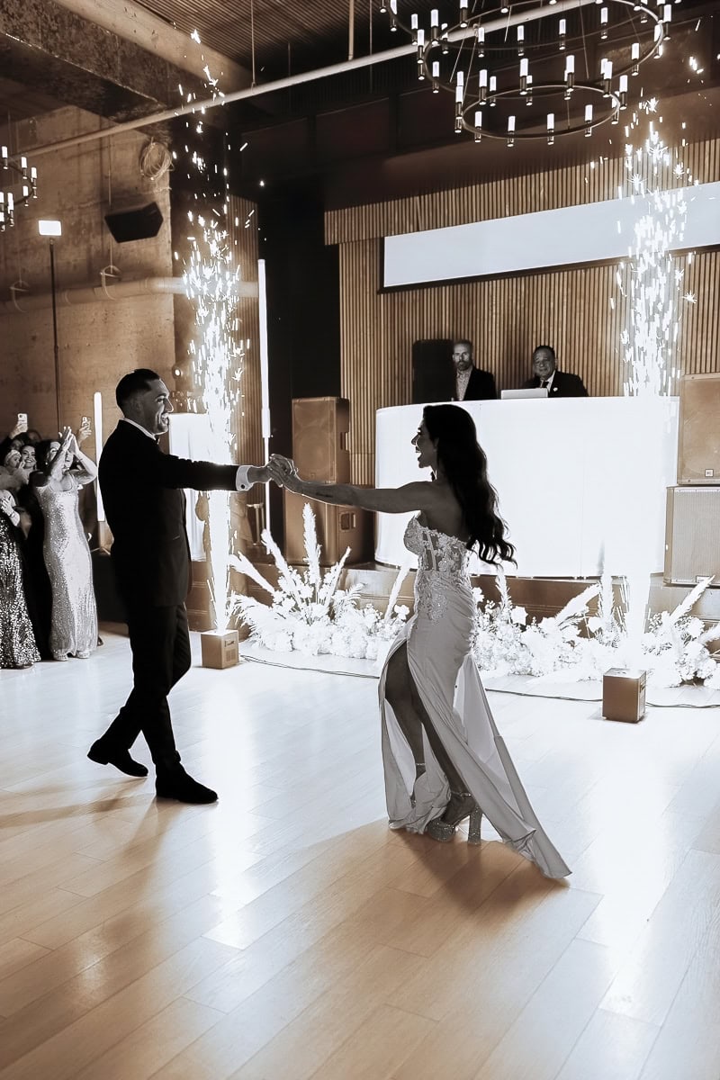 Black-and-white first dance with indoor sparklers, floral aisle, and DJ booth at The Switch House by Cescaphe, Philadelphia.